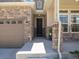 Welcoming front porch featuring stone pillars, neutral siding, and an elegant black front door at 16448 E 111Th Pl, Commerce City, CO 80022