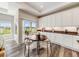 Bright breakfast nook featuring a wood table, patio access, and white cabinets at 16448 E 111Th Pl, Commerce City, CO 80022