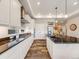 Modern kitchen featuring white cabinets, dark countertops, and stainless steel appliances for a luxurious cooking experience at 16448 E 111Th Pl, Commerce City, CO 80022