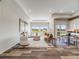 Spacious living room with hardwood floors, an area for dining, and an abundance of natural light at 16448 E 111Th Pl, Commerce City, CO 80022
