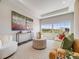 Bright living room featuring large windows, modern decor, neutral color palette and contemporary furnishings at 16448 E 111Th Pl, Commerce City, CO 80022