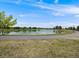 Scenic pond surrounded by a walking path, offering a peaceful and serene outdoor space at 16448 E 111Th Pl, Commerce City, CO 80022