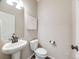 Powder room featuring a pedestal sink, stylish fixtures, and neutral decor at 16448 E 111Th Pl, Commerce City, CO 80022