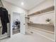 Walk-in closet features carpet flooring and shelving for optimal storage and organization of clothes at 16448 E 111Th Pl, Commerce City, CO 80022