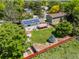 Aerial view of the home featuring solar panels, a deck, patio, and fenced backyard with mature trees at 1245 Ceres Dr, Lafayette, CO 80026