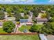 Aerial view of the home highlighting a backyard with mature trees, solar panels, deck, and backyard at 1245 Ceres Dr, Lafayette, CO 80026