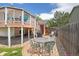 Back patio area with outdoor furniture, gas grill, access to elevated composite deck and fenced backyard at 1245 Ceres Dr, Lafayette, CO 80026