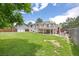 Green backyard with wooden deck, shed, lush grass, and fencing at 1245 Ceres Dr, Lafayette, CO 80026