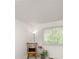 Cozy bedroom featuring a comfy rocking chair, plants, and natural light from a window at 1245 Ceres Dr, Lafayette, CO 80026