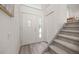 Bright entryway featuring tile floors, a staircase, and a coat closet at 1245 Ceres Dr, Lafayette, CO 80026