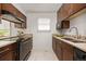 Well-lit kitchen featuring granite counters, stainless steel appliances, and abundant wood cabinetry at 1245 Ceres Dr, Lafayette, CO 80026