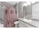 Cozy bathroom featuring a tub with shower, single sink vanity, and a patterned shower curtain at 6577 S Kewaunee Way, Aurora, CO 80016