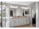 Bright bathroom featuring double sinks and a large mirror at 6577 S Kewaunee Way, Aurora, CO 80016