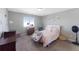 A clean bedroom with plush carpet, a bed, and a window at 6577 S Kewaunee Way, Aurora, CO 80016