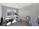 Bedroom featuring carpet, large windows, and a comfortable seating area, perfect for relaxation at 6577 S Kewaunee Way, Aurora, CO 80016