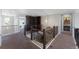 Hallway featuring wooden banisters, decorative accents, and access to multiple rooms and living spaces at 6577 S Kewaunee Way, Aurora, CO 80016