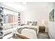 Light-filled bedroom with a comfortable bed and a large window showcasing a neighborhood view at 5527 W 11Th Pl, Lakewood, CO 80214