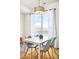 Elegant dining space bathed in natural light, showcasing a modern table and stylish decor at 5527 W 11Th Pl, Lakewood, CO 80214