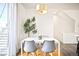 Cozy dining area with a modern table, stylish chairs, and natural light from the nearby window at 5527 W 11Th Pl, Lakewood, CO 80214