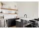 Chic bar area with a wine refrigerator, stylish shelving, and elegant countertops at 5831 Galena St, Denver, CO 80238