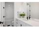 Stylish bathroom features modern black hardware, patterned tile floor, and a tub with white subway tile at 5831 Galena St, Denver, CO 80238