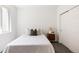Cozy bedroom with a comfortable bed, a side table with a lamp, and a closet with sliding doors at 5831 Galena St, Denver, CO 80238