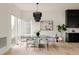 Bright dining room with a modern chandelier, large windows, and ample natural light at 5831 Galena St, Denver, CO 80238
