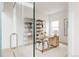 Bright home office with sleek wooden desk, chair, and shelving units for stylish storage and decor at 5831 Galena St, Denver, CO 80238