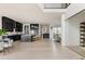 Spacious open-concept kitchen with dark cabinets, a large island with seating, and modern appliances at 5831 Galena St, Denver, CO 80238