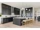 Stylish kitchen featuring dark cabinetry, quartz countertops, stainless steel appliances, and a center island at 5831 Galena St, Denver, CO 80238