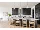Beautiful kitchen with pendant lighting, a large island with seating, and stainless steel appliances at 5831 Galena St, Denver, CO 80238