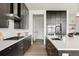 Modern kitchen with dark cabinets, white countertops, stainless steel appliances, and a gas cooktop at 5831 Galena St, Denver, CO 80238