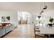 Bright open-concept space with modern kitchen island, dining area, and living room setup at 5831 Galena St, Denver, CO 80238