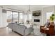 Cozy living room featuring a modern fireplace, large sliding doors, and stylish decor at 5831 Galena St, Denver, CO 80238