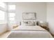 Serene main bedroom with neutral decor, natural light, and stylish modern furniture at 5831 Galena St, Denver, CO 80238