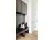 Mud room featuring a built-in bench with storage, coat hooks, and sleek gray cabinets at 5831 Galena St, Denver, CO 80238
