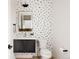 Modern powder room featuring black and white spotted wallpaper and modern fixtures at 5831 Galena St, Denver, CO 80238