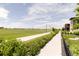 Enjoy the outdoors on this inviting walking path, next to a large, green field in this vibrant community at 5831 Galena St, Denver, CO 80238