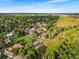 Expansive aerial perspective highlighting the property's serene location, surrounded by lush greenery and established neighborhoods at 5115 Bristol St, Arvada, CO 80002