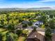 Overhead shot of neighborhood with gorgeous home nestled among mature trees and open fields at 5115 Bristol St, Arvada, CO 80002