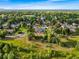 Stunning aerial shot of the neighborhood featuring tree-lined streets, lush landscapes, and charming homes at 5115 Bristol St, Arvada, CO 80002