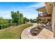 Expansive backyard with a stone patio, wooden deck, and lush greenery, perfect for outdoor enjoyment and entertaining at 5115 Bristol St, Arvada, CO 80002