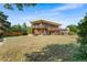 Expansive backyard with a large lawn and multi-level deck overlooking the yard at 5115 Bristol St, Arvada, CO 80002