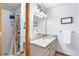 Bathroom featuring a granite vanity, and a walk-in shower at 5115 Bristol St, Arvada, CO 80002