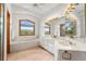 Bright bathroom featuring double sinks, large windows, and a soaking tub at 5115 Bristol St, Arvada, CO 80002