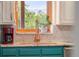 Close up of a well-appointed kitchen sink with stunning mountain views at 5115 Bristol St, Arvada, CO 80002