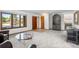 Spacious living room with carpeted floors, a large glass table, and staircase at 5115 Bristol St, Arvada, CO 80002
