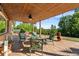 Covered patio with a dining set, overhead lights, and a view of the lush backyard at 5115 Bristol St, Arvada, CO 80002
