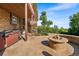Spacious outdoor patio with a fire pit, seating, and space for a grill and hot tub at 5115 Bristol St, Arvada, CO 80002