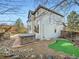 Backyard featuring outdoor kitchen, hot tub, and putting green with rocks around the perimeter at 10672 Wintersweet Pl, Parker, CO 80134